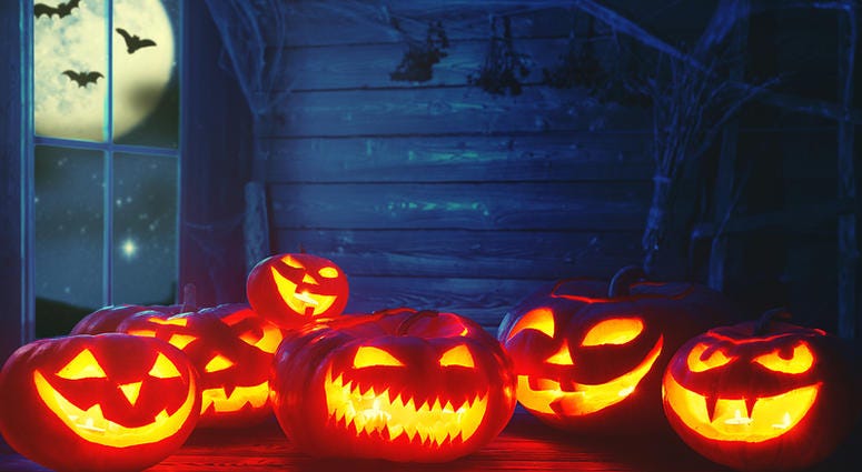 Spooky halloween background. scary pumpkin with burning eyes Spooky halloween background. scary pumpkin with burning eyes