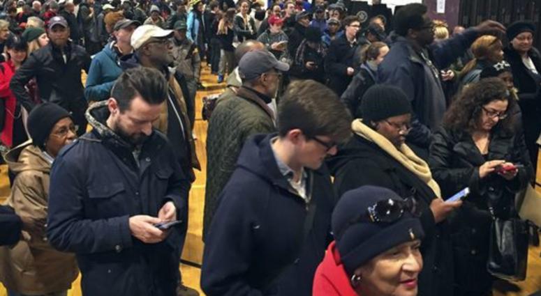 Voters line up in crowds at a polling site to cast their ballots, Tuesday Nov. 8, 2016, in the Flatbush section of Brooklyn in New York.