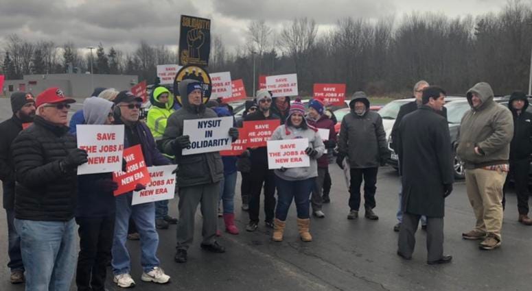 Protesters gather outside the New Era plant in Derby to protest the company's decision to lay off workers and move manufacturing elsewhere.