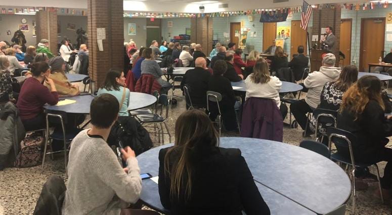 Community gathers at Southside Elementary for town meeting regarding change in law enforcement shift times.