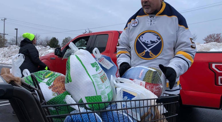 Craig Muni from the Buffalo Sabres volunteers in the 2019 Turkeys for Tickets drive. November 20, 2019 (WBEN Photo/Mike Baggerman)