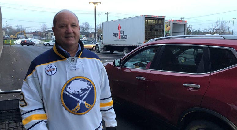 Derek Smith from the Buffalo Sabres volunteers at Turkeys for Tickets. November 20, 2019 (WBEN Photo/Mike Baggerman)