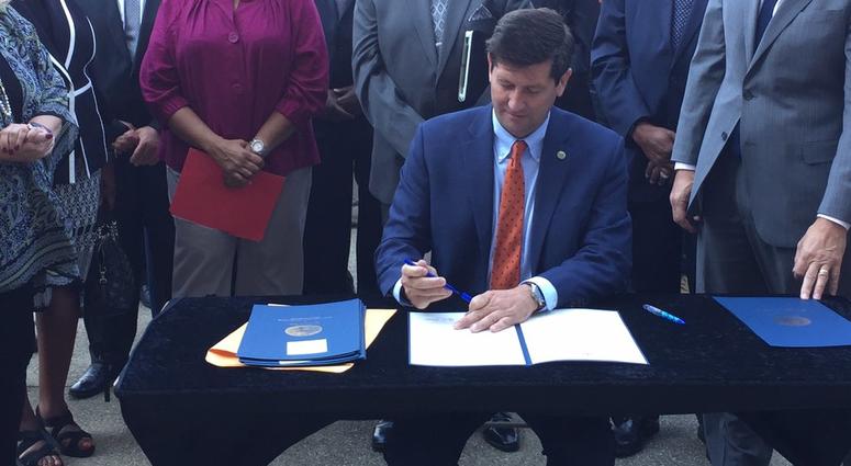 Erie County Executive Mark Poloncarz signs the First Source Hiring Policy Executive Order (WBEN Photo/Mike Baggerman)