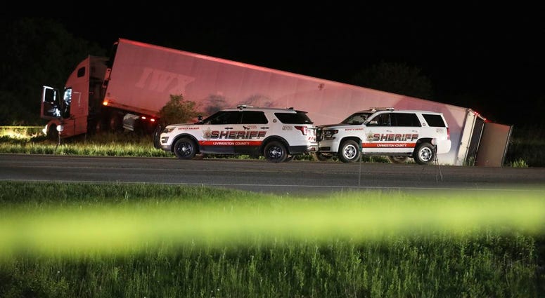 Livingston County Sheriff's work at the scene of cab of a tractor trailer after the driver was killed during a shootout with law enforcement officers