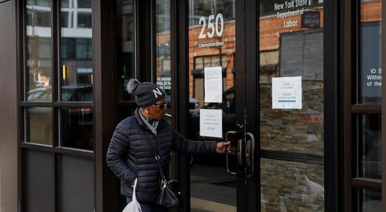 Visitors are unable to gain access to the Department of Labor due to closures over coronavirus concerns, Wednesday, March 18, 2020, in New York.