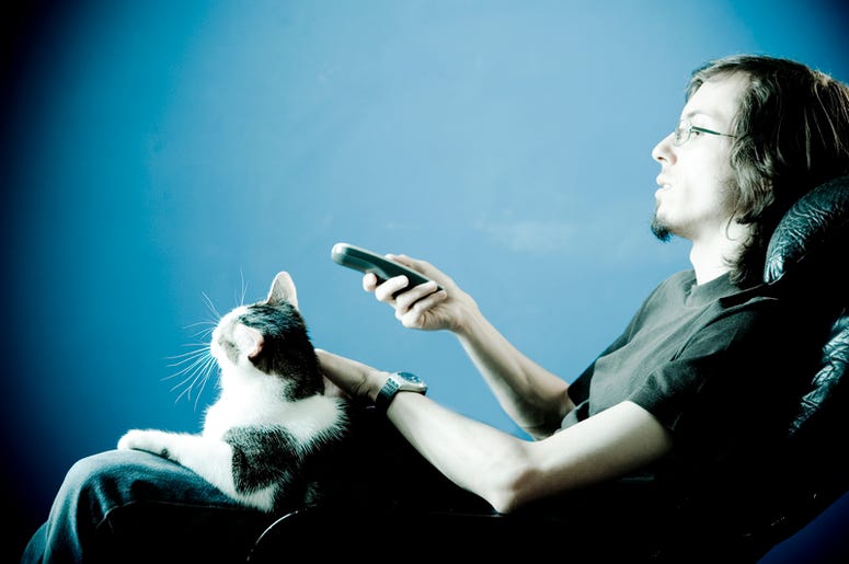 Man Binge Watching TV with a Cat Man Binge Watching TV with a Cat