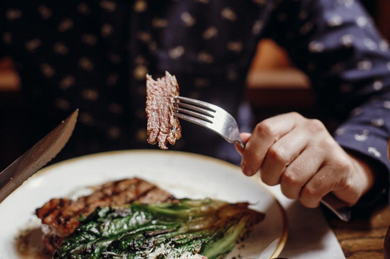Person eating meat Person eating meat