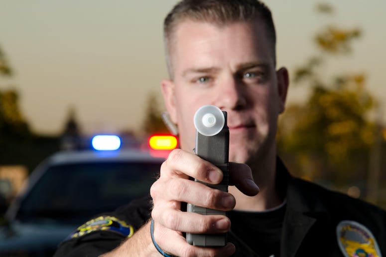 Cop with a breathalyzer Cop with a breathalyzer