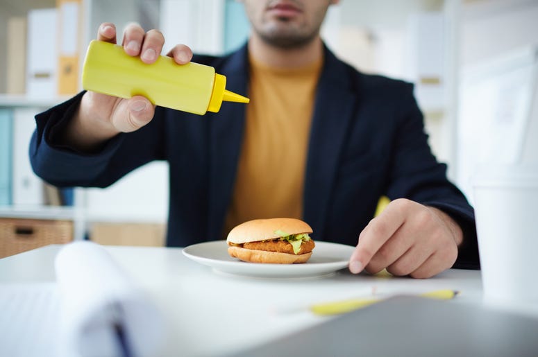Man pouring out mustard