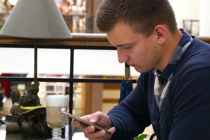 Man Scrolling Through Phone Man Scrolling Through Phone