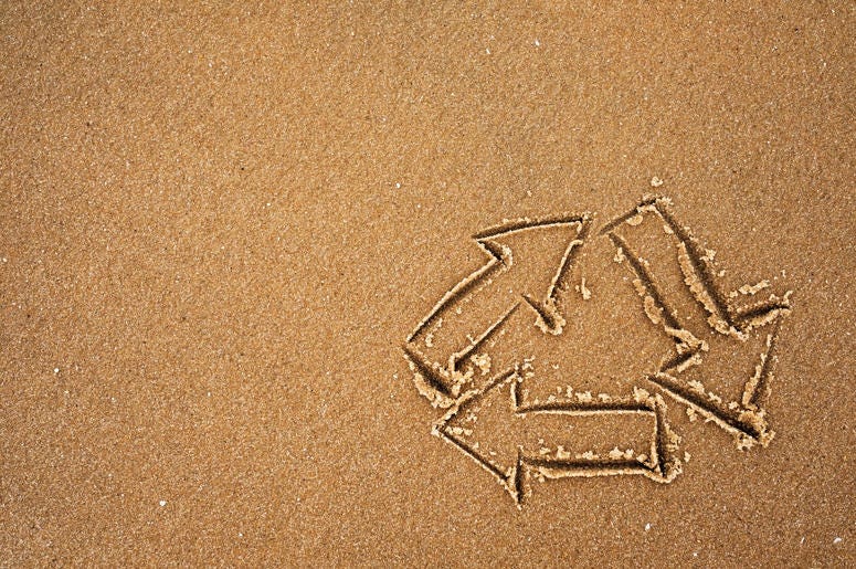 Recycle symbol on beach