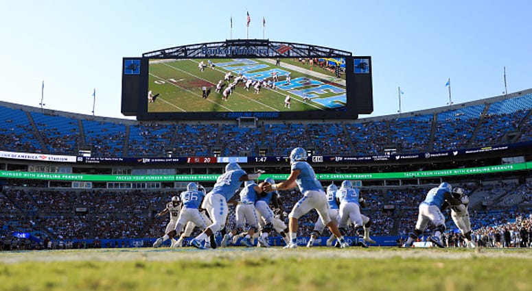CHARLOTTE, NORTH CAROLINA - AUGUST 31: Sam Howell #7 of the North Carolina Tar Heels hands the ball off to teammate Antonio Williams #24 of the North Carolina Tar Heels during the Belk College Kickoff game at Bank of America Stadium on August 31, 2019 in