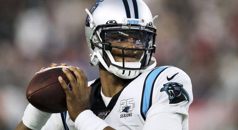 Carolina Panthers quarterback Cam Newton warms up before an NFL preseason football game.