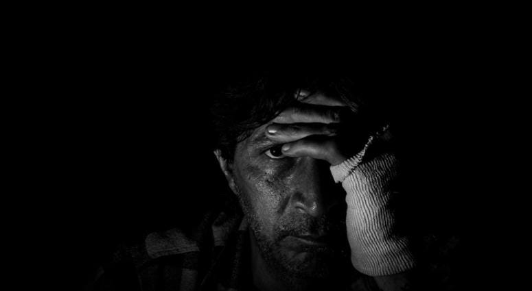 Man sitting alone in dark room