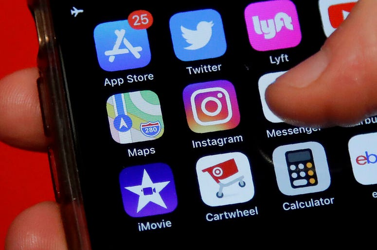 a phone showing the Instagram app icon a phone showing the Instagram app icon