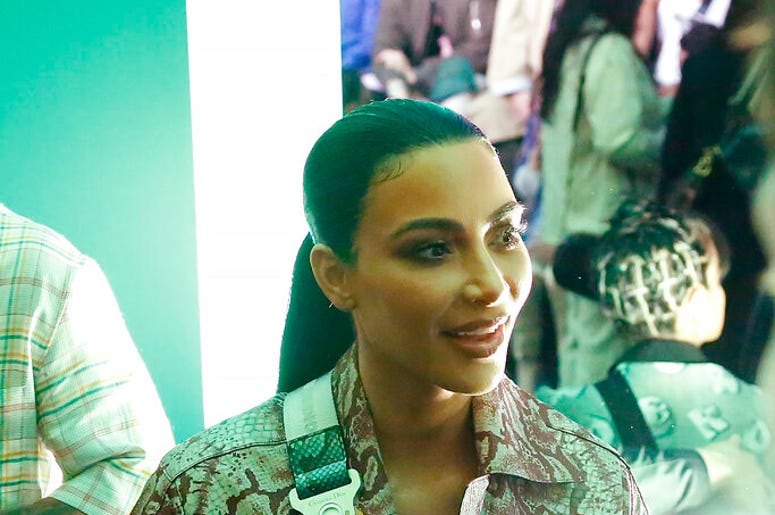 In this Tuesday, Dec. 3, 2019, photo, actress Kim Kardashian waits for the Christian Dior pre-fall 2020 men's fashion show to start during Miami Art week, in Miami.