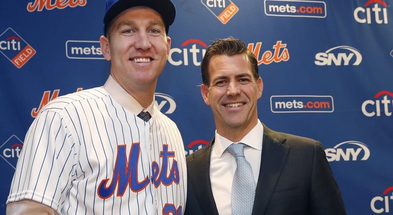 In this Wednesday, Feb. 7, 2018, file photo, New York Mets newly-signed third baseman Todd Frazier, left, poses for photographers with his agent, Brodie Van Wagenen, after the former New York Yankees third baseman signed with the Mets, in New York. Brodie Van Wagenen