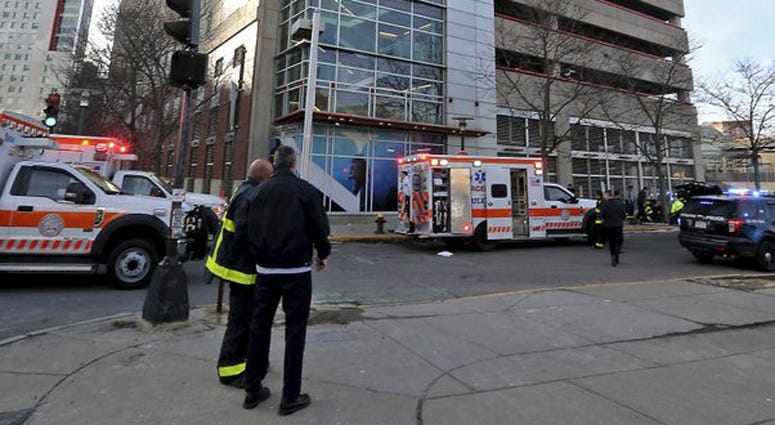 Emergency personnel at the scene of an incident at the Renaissance Park Garage where an adult and 2 children fell from the garage and were found dead on a sidewalk near the Boston parking garage on Christmas Day, Wednesday, Dec. 25, 2019. Boston Murder Suicide