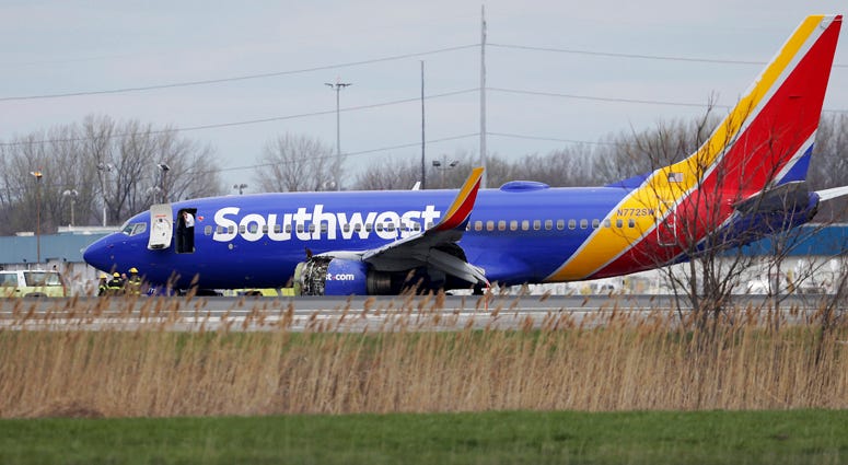 A Southwest Airlines plane sits on the runway at the Philadelphia International Airport after it made an emergency landing in Philadelphia, on Tuesday, April 17, 2018. Southwest Airlines Emergency Landing