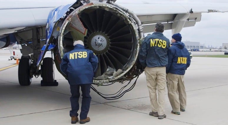In this Tuesday, April 17, 2018 frame from video, a National Transportation Safety Board investigator examines damage to the engine of the Southwest Airlines plane that made an emergency landing at Philadelphia International Airport in Philadelphia. Southwest Airlines Emergency Landing