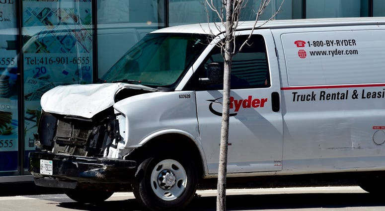 A van with a damaged front-end sits idle on a sidewalk after the driver drove down a sidewalk crashing into a number of pedestrians in Toronto, Monday, April 23, 2018. Toronto Van Attack
