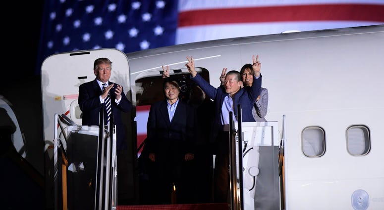 resident Donald Trump, from left, greets Tony Kim, Kim Hak Song, seen in the shadow, and Kim Dong Chul Americans Freed By North Korea