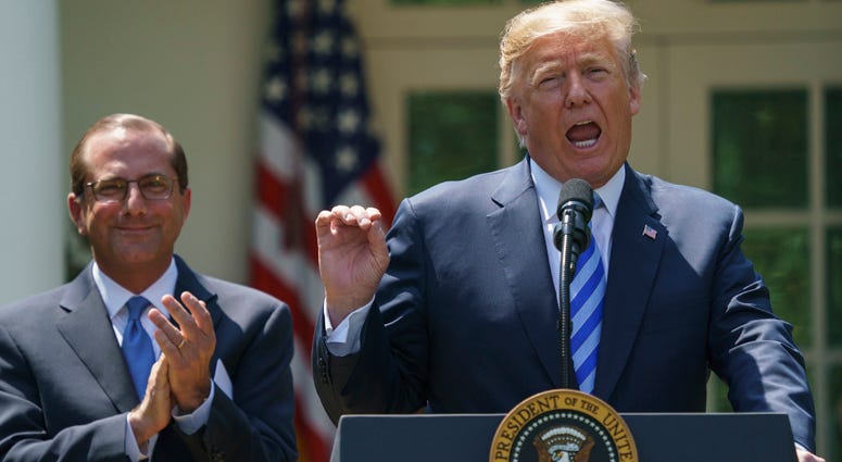 President Donald Trump speaks during an event about prescription drug prices with Health and Human Services Secretary Alex Azar, left, in the Rose Garden of the White House in Washington, Friday, May 11, 2018. Donald Trump Drug Plan