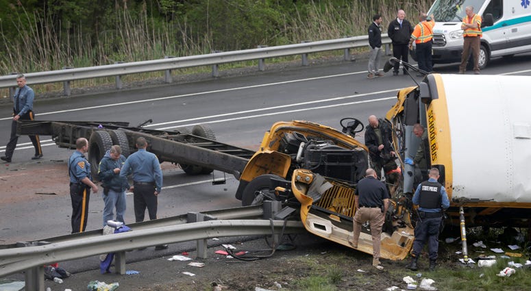 Emergency personnel work at the scene of a school bus and dump truck collision, injuring multiple people, on Interstate 80 in Mount Olive, N.J., Thursday, May 17, 2018. Deadly New Jersey School Bus Crash