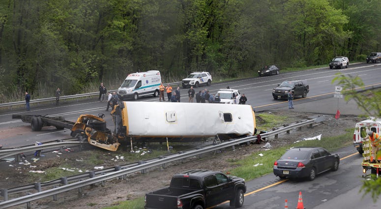 Emergency personnel work at the scene of a school bus and dump truck collision, injuring multiple people, on Interstate 80 in Mount Olive, N.J., Thursday, May 17, 2018. Deadly New Jersey School Bus Crash