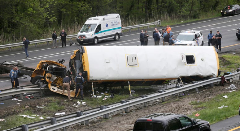 Emergency personnel work at the scene of a school bus and dump truck collision, injuring multiple people, on Interstate 80 in Mount Olive, N.J., Thursday, May 17, 2018. Deadly New Jersey School Bus Crash