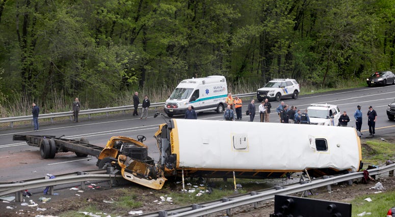 Emergency personnel work at the scene of a school bus and dump truck collision, injuring multiple people, on Interstate 80 in Mount Olive, N.J., Thursday, May 17, 2018. Deadly New Jersey School Bus Crash