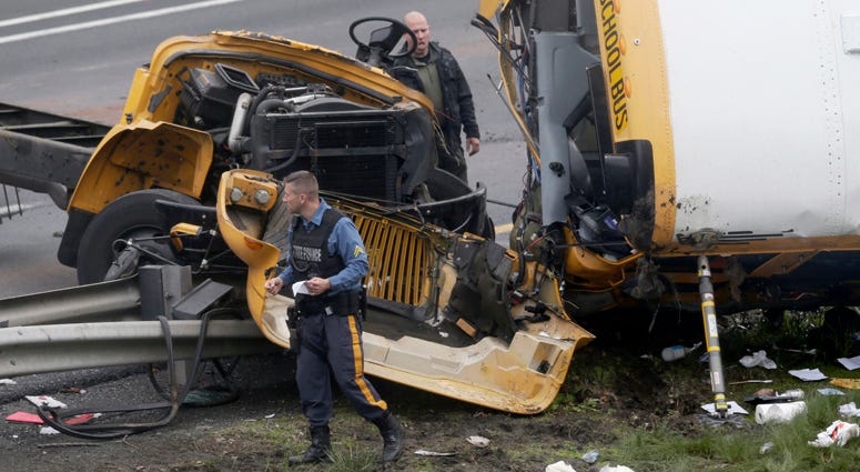 Emergency personnel work at the scene of a school bus and dump truck collision, injuring multiple people, on Interstate 80 in Mount Olive, N.J., Thursday, May 17, 2018. Deadly New Jersey School Bus Crash