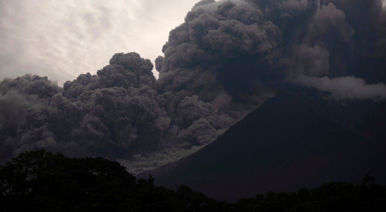 In this image taken with a long exposure, the Volcan de Fuego, or Volcano of Fire, spews molten rock from its crater in Alotenango, Guatemala, Sunday, June 3, 2018. Guatemala Volcano