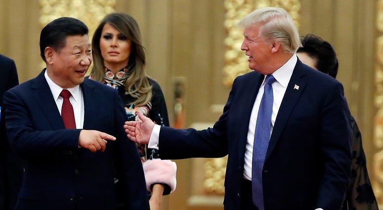 In this Nov. 9, 2017, file photo, U.S. President Donald Trump China's President Xi Jinping arrive for the state dinner with the first ladies at the Great Hall of the People in Beijing, China. Trump And China's President