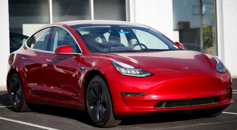 In this May 27, 2018, file photo, a 2018 Model 3 sedan sits at a Tesla dealership in Littleton, Colo. Tesla 2018 Model 3