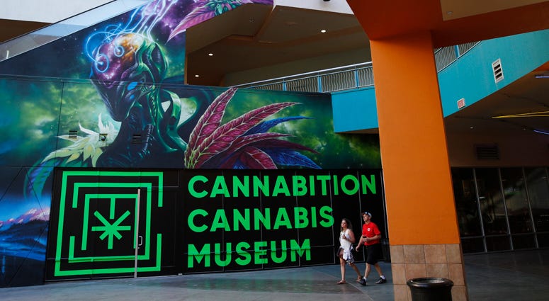In this Tuesday, Sept. 18, 2018 photo, people walk by the Cannabition cannabis museum in Las Vegas.