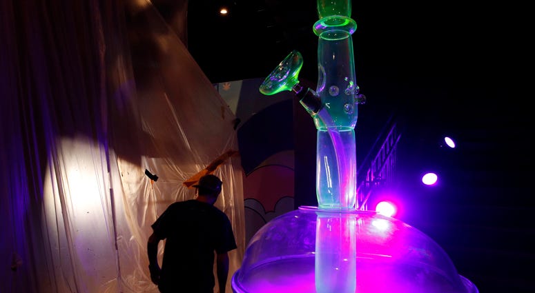 In this Tuesday, Sept. 18, 2018 photo, a man walks by a 24-foot-tall bong at the Cannabition cannabis museum in Las Vegas
