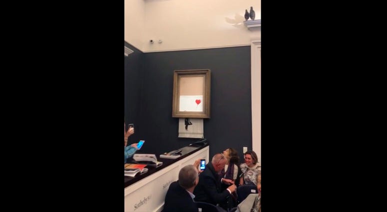 The artwork self-destructed at auction. Banksy Self Destructing Art