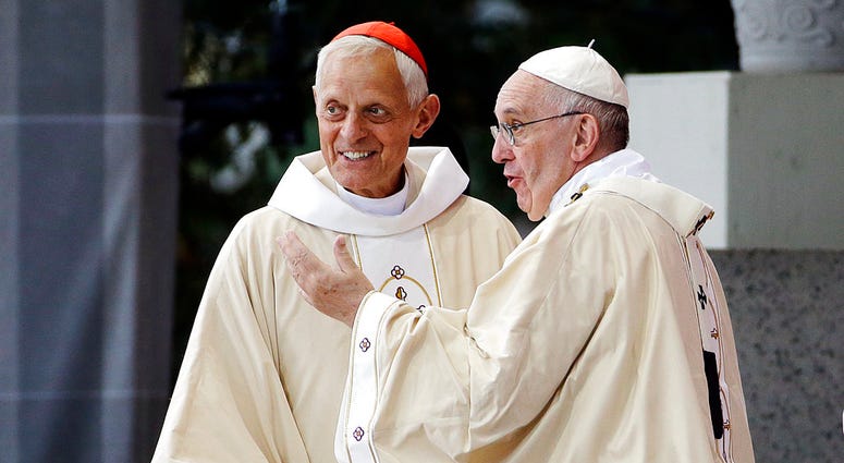 Cardinal Donald Wuerl, archbishop of Washington, left, talking with Pope Francis