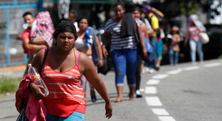 Central American migrants making their way to the U.S. arrive by foot to Tapachula, Mexico, Sunday, Oct. 21, 2018. Migrant caravan