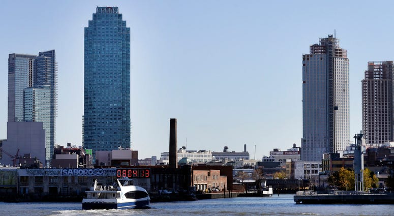 In this Nov. 7, 2018 file photo, a water taxi approaches the Long Island City waterfront and skyline, in the Queens borough of New York. Long Island City Amazon