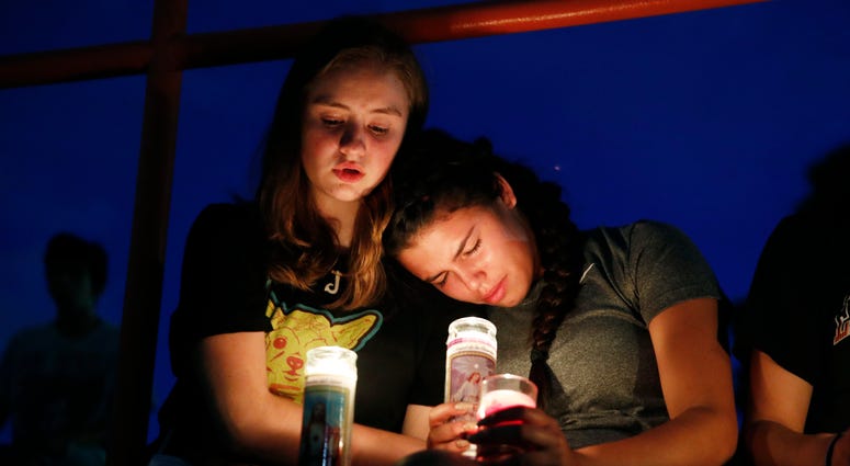 Melody Stout and Hannah Payan comfort each other during a vigil for victims of the shooting that occurred earlier in the day at a shopping center, Saturday, Aug. 3, 2019, in El Paso, Texas. El Paso Shooting