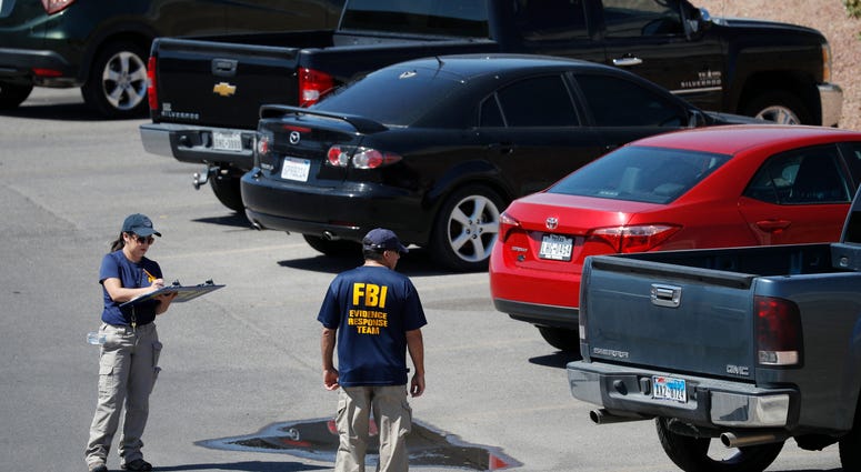 Members of the FBI evidence response team investigate the scene of a mass shooting at a shopping complex Sunday, Aug. 4, 2019, in El Paso, Texas. El Paso shooting