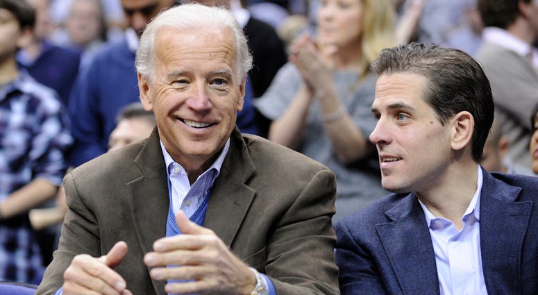 In this Jan. 30, 2010, file photo, Vice President Joe Biden, left, with his son Hunter, right, at the Duke Georgetown NCAA college basketball game in Washington. Joe Biden, Hunter Biden
