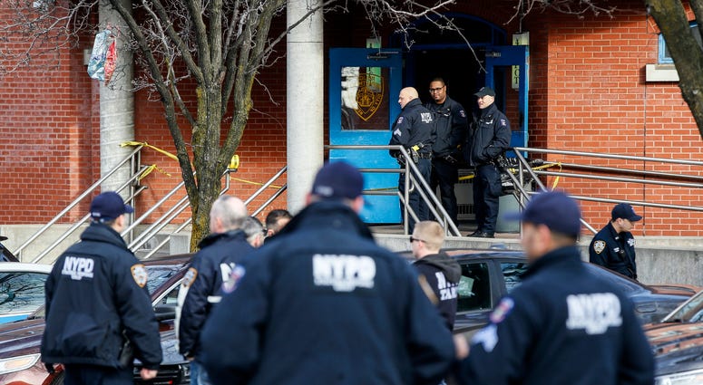 New York City police officers work the scene of a police involved shooting outside the 41st precinct Sunday, Feb. 9, 2020, in New York. NYPD officers shot