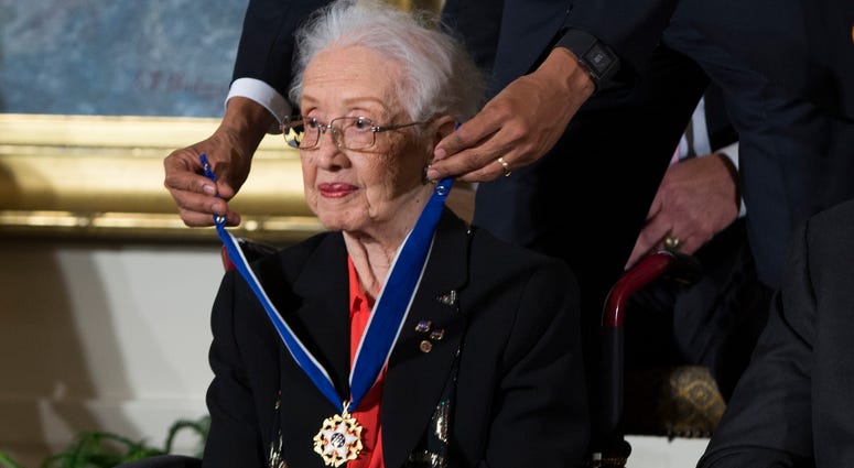 FILE - In this Nov. 24, 2015 photo, Willie Mays, right, looks on as President Barack Obama presents the Presidential Medal of Freedom to NASA mathematician Katherine Johnson during a ceremony in the East Room of the White House, in Washington. Katherine Johnson
