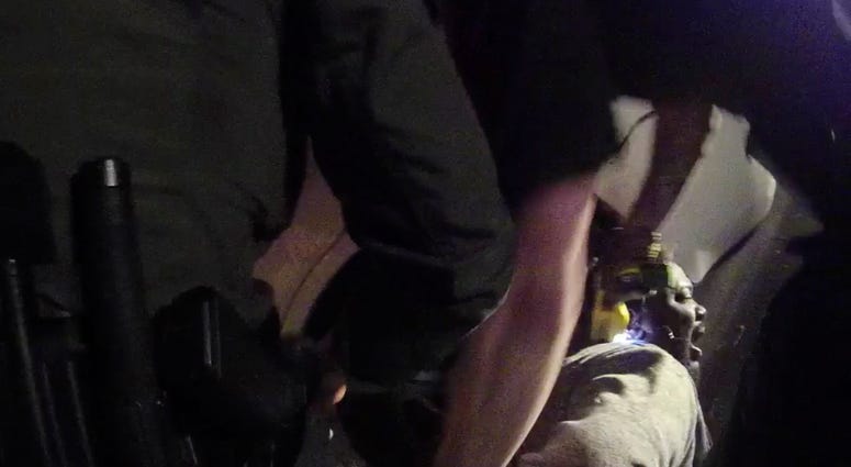 In this image made from a March 28, 2019, body-worn camera video provided by the Austin Police Department in Texas, Williamson County deputies hold down Javier Ambler as one of them uses a Taser on Ambler’s back during his arrest in Austin, Texas. Live PD