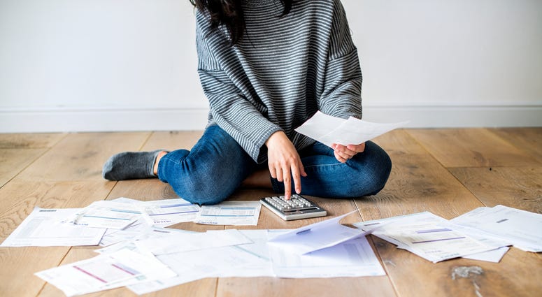 Paying bills on the floor Paying bills on the floor