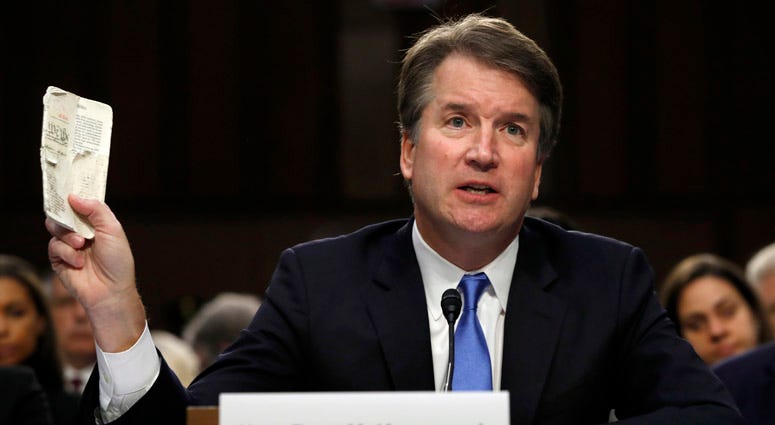 Supreme Court nominee Brett Kavanaugh, a federal appeals court judge, holds up a pocket copy of the Constitution as he testifies before the Senate Judiciary Committee on Capitol Hill in Washington, Wednesday, Sept. 5, 2018. Brett Kavanaugh