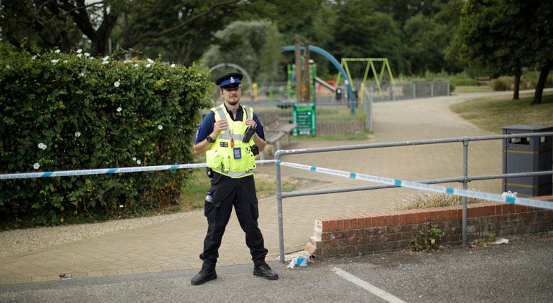 A British police community support officer guards a cordon outside the Queen Elizabeth Gardens park in Salisbury, England, Thursday, July 5, 2018. British Couple Poisoned
